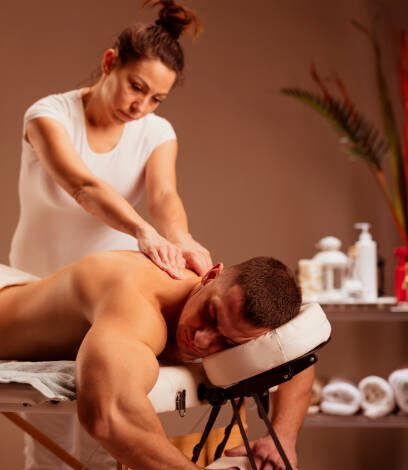 Massage Therapist woman doing healing massage. Man enjoying in relaxing massaging at health spa treatment.